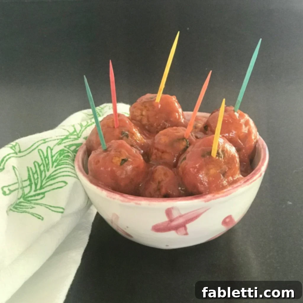 A small dish brimming with colorful vegan sweet and sour meatballs, each adorned with a vibrant toothpick, inviting guests to enjoy a fun, tasty, and healthy appetizer.
