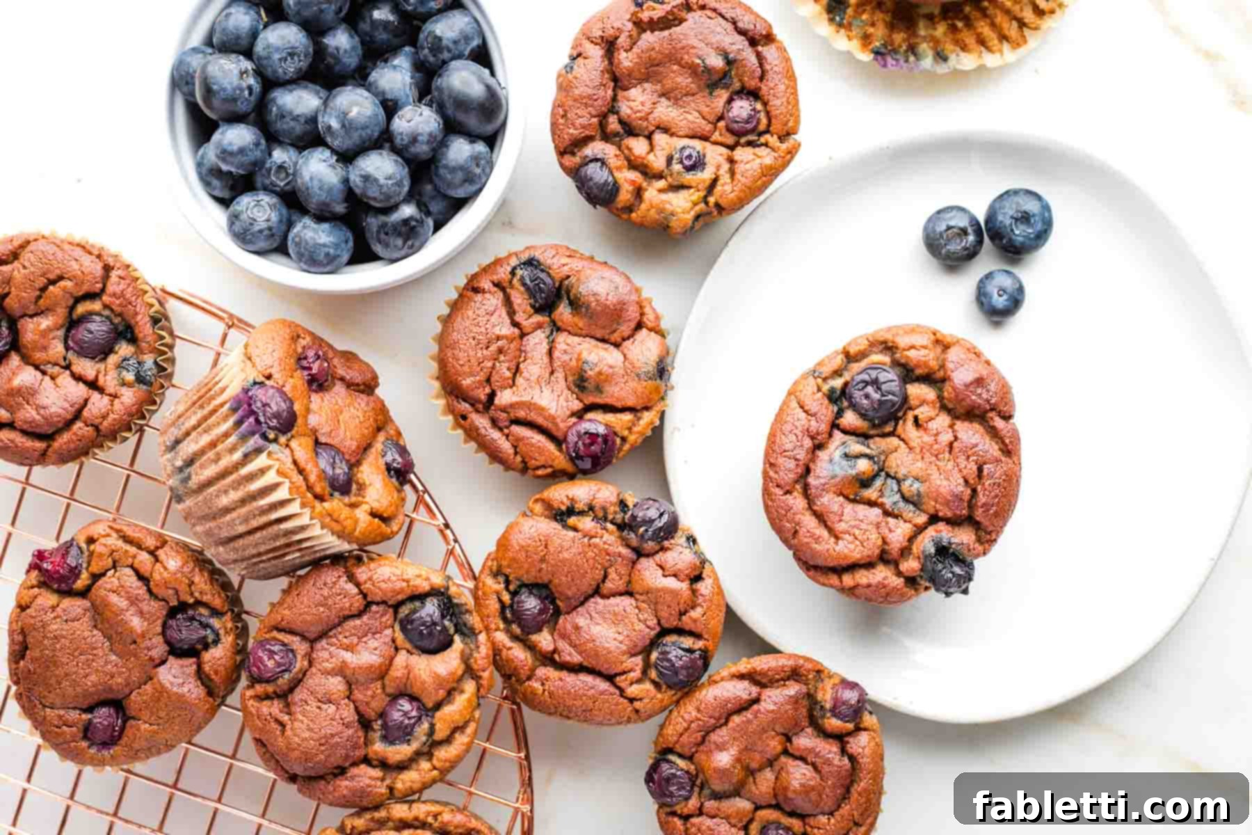 Quick Blender Almond Blueberry Muffins 10 A close-up of a perfectly baked almond flour blueberry muffin, highlighting its fluffy texture and juicy blueberries.