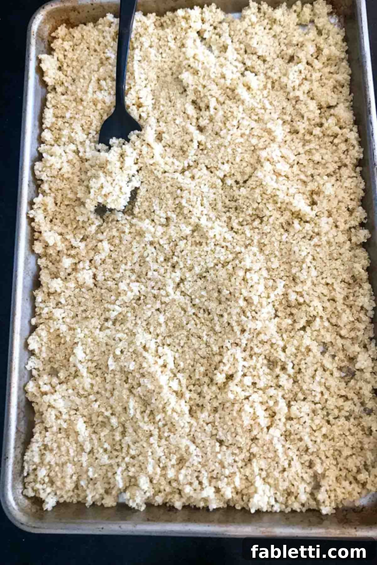 A close-up image showing a fresh orange cut in half, illustrating a key ingredient for the vibrant citrus dressing, surrounded by the inviting green hues of the dish.