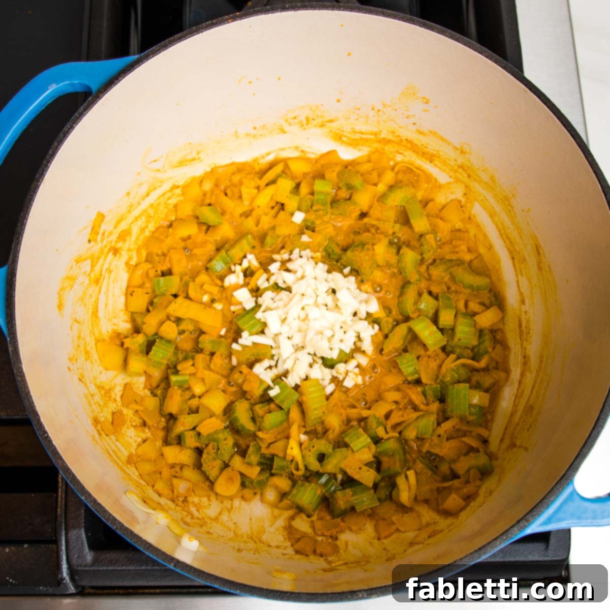 Nourishing Parsnip and Kale Soup 11 Turmeric-sautéed onions and celery, with chopped garlic added on top.
