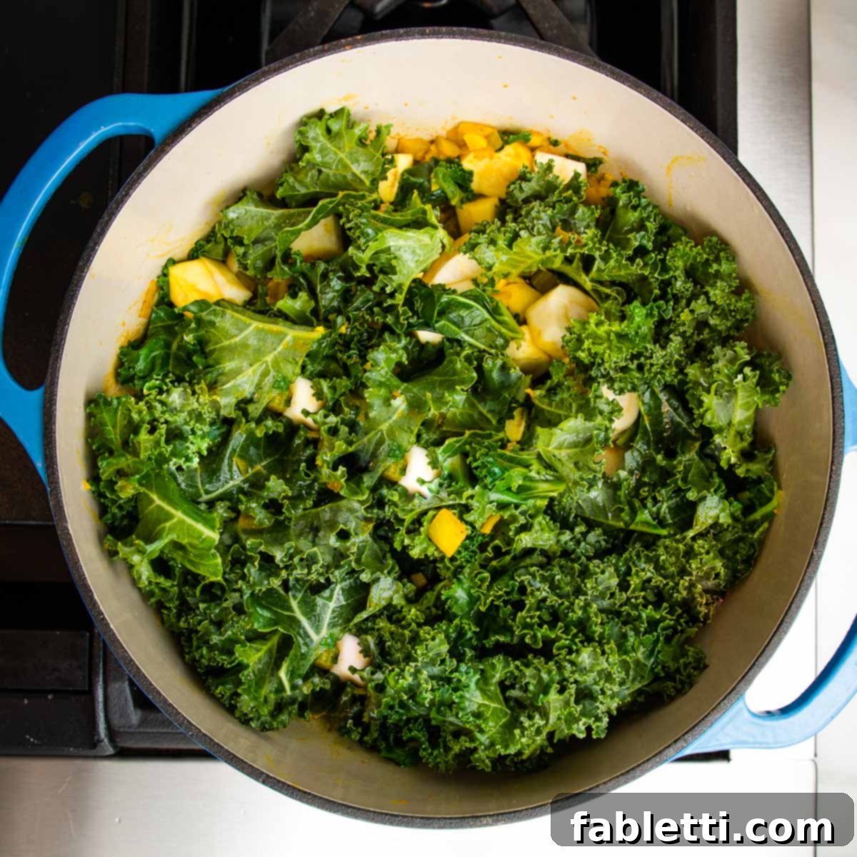 Nourishing Parsnip and Kale Soup 13 Wilted kale, parsnips, and onions in a Dutch oven, ready for broth.