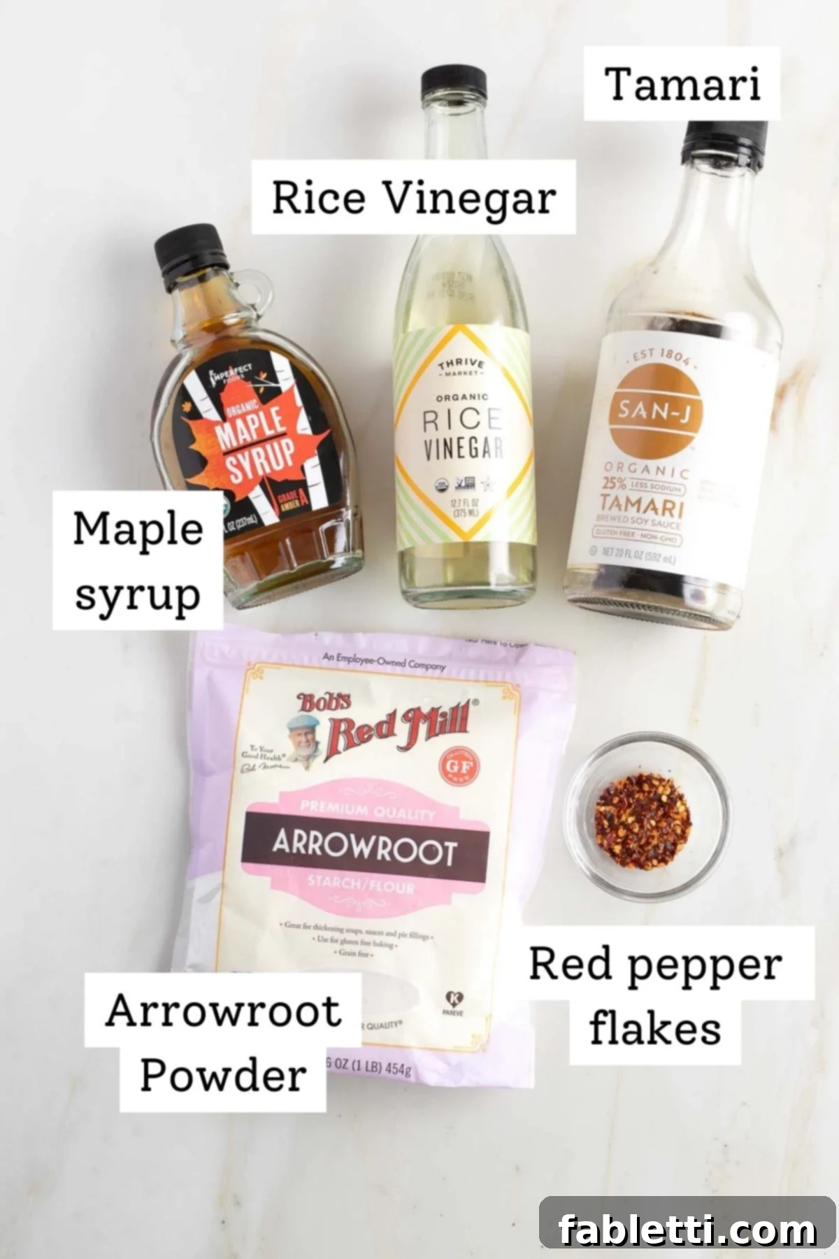 Quick and Flavorful Teriyaki Vegetable Stir-Fry 3 Labeled ingredients for teriyaki sauce: tamari, rice vinegar, maple syrup, arrowroot powder, red pepper flakes.