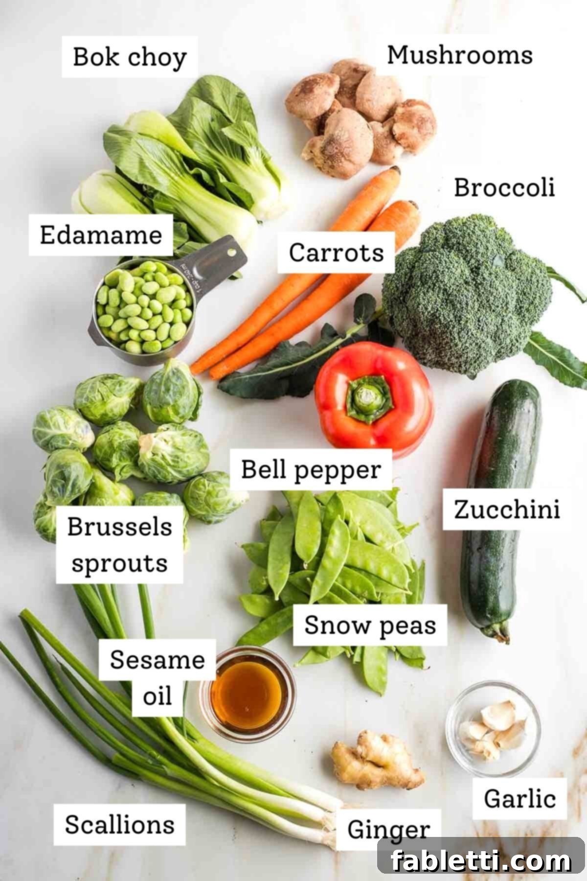 Quick and Flavorful Teriyaki Vegetable Stir-Fry 4 Labeled ingredients: bok choy, mushrooms, bell pepper, carrots, broccoli, brussels sprouts, zucchini, snow peas, scallions, sesame oil, ginger, garlic.