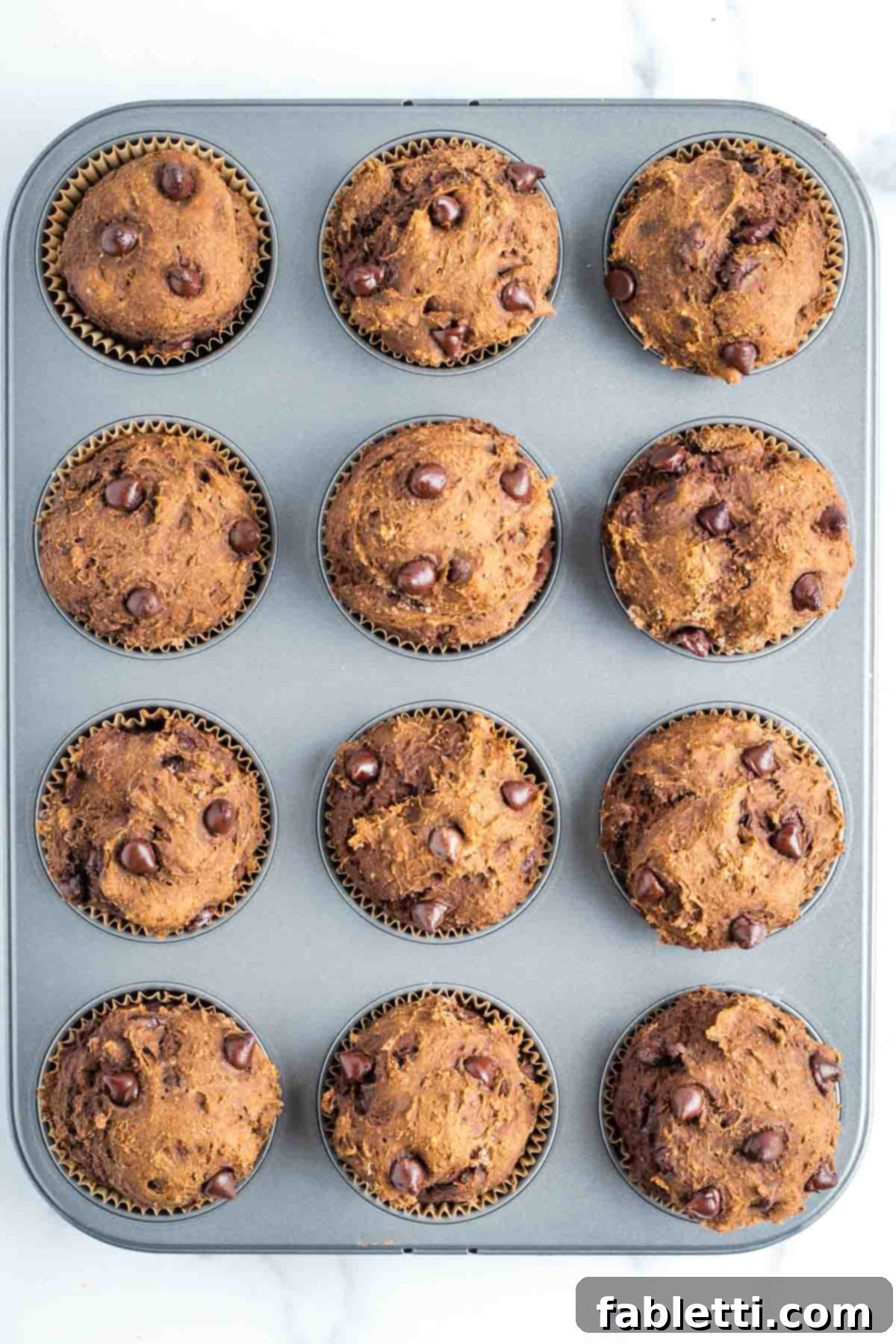 Decadent Vegan Double Chocolate Flax Muffins 11 Double chocolate chocolate chip muffins in the baking tin, freshly scooped and ready for the oven.
