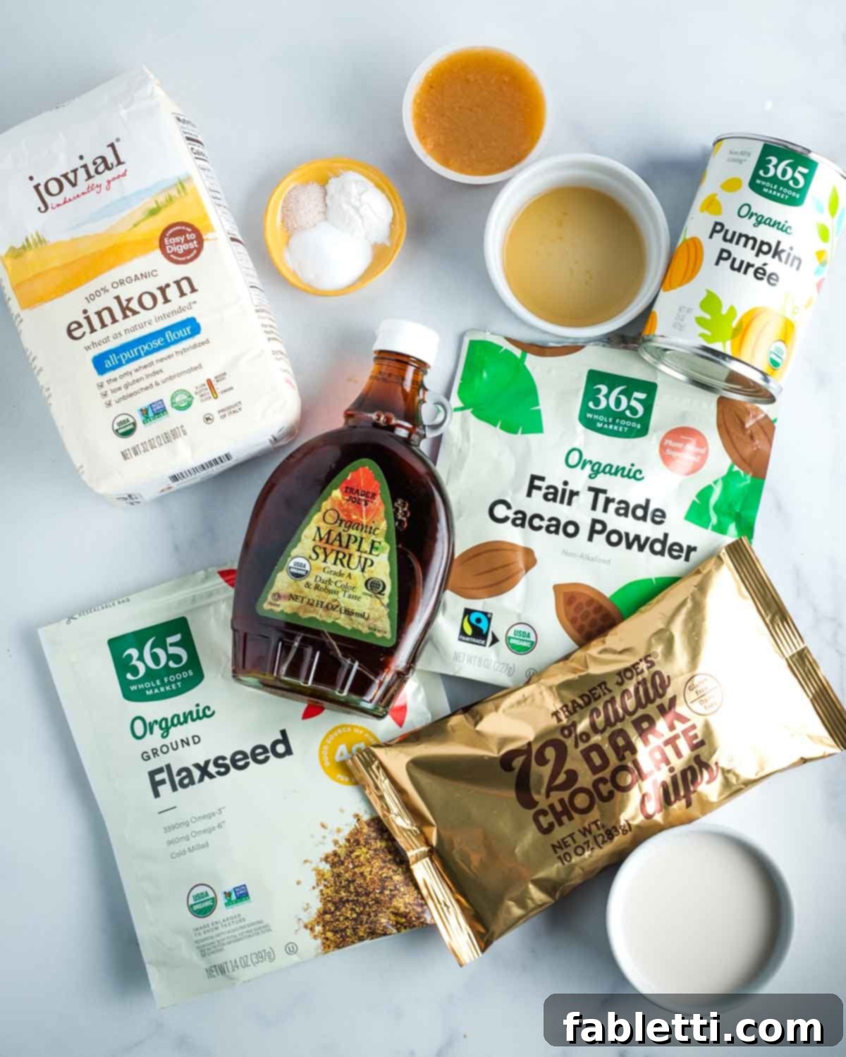 Decadent Vegan Double Chocolate Flax Muffins 3 A flat lay of ingredients for double chocolate muffins: all-purpose flour, maple syrup, unsweetened applesauce, apple cider vinegar, cacao powder, ground flaxseeds, pumpkin puree, and almond milk.