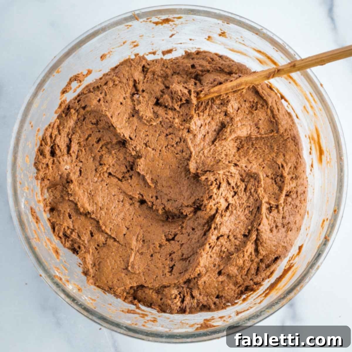 Decadent Vegan Double Chocolate Flax Muffins 8 Chocolate muffin batter in a glass mixing bowl, showing slightly lumpy consistency.