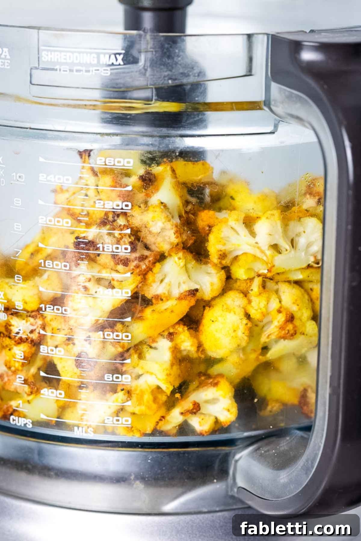 Smoky Roasted Cauliflower Hummus 8 Roasted cauliflower florets in the bowl of food processor.