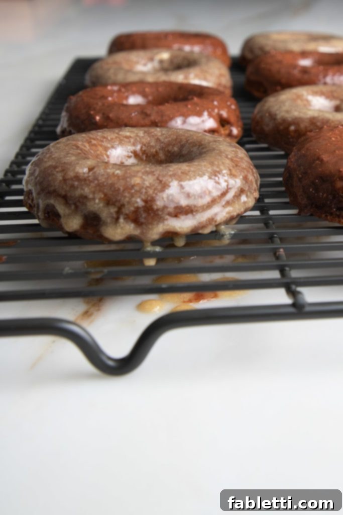 Gluten-Free Baked Pumpkin Spice Doughnuts 8 Pumpkin donuts dripping with a luscious maple glaze, glistening and inviting.
