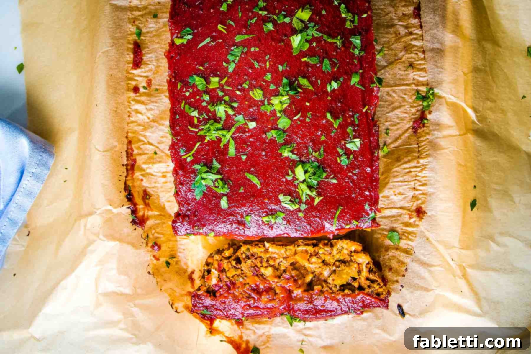 Hearty Plant-Based Meatloaf 15 A beautifully baked vegan meatloaf topped with a rich tomato sauce, with one perfect slice cut to reveal its inviting interior.