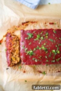 Hearty Plant-Based Meatloaf 19 A thick slice of vegan meatloaf with tomato glaze.