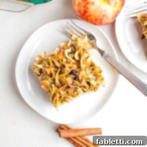 Delicious Dairy-Free Apple Noodle Kugel 16 A golden-brown piece of apple noodle kugel with sweet raisins, ready to be served from a festive Jewish holiday meal.