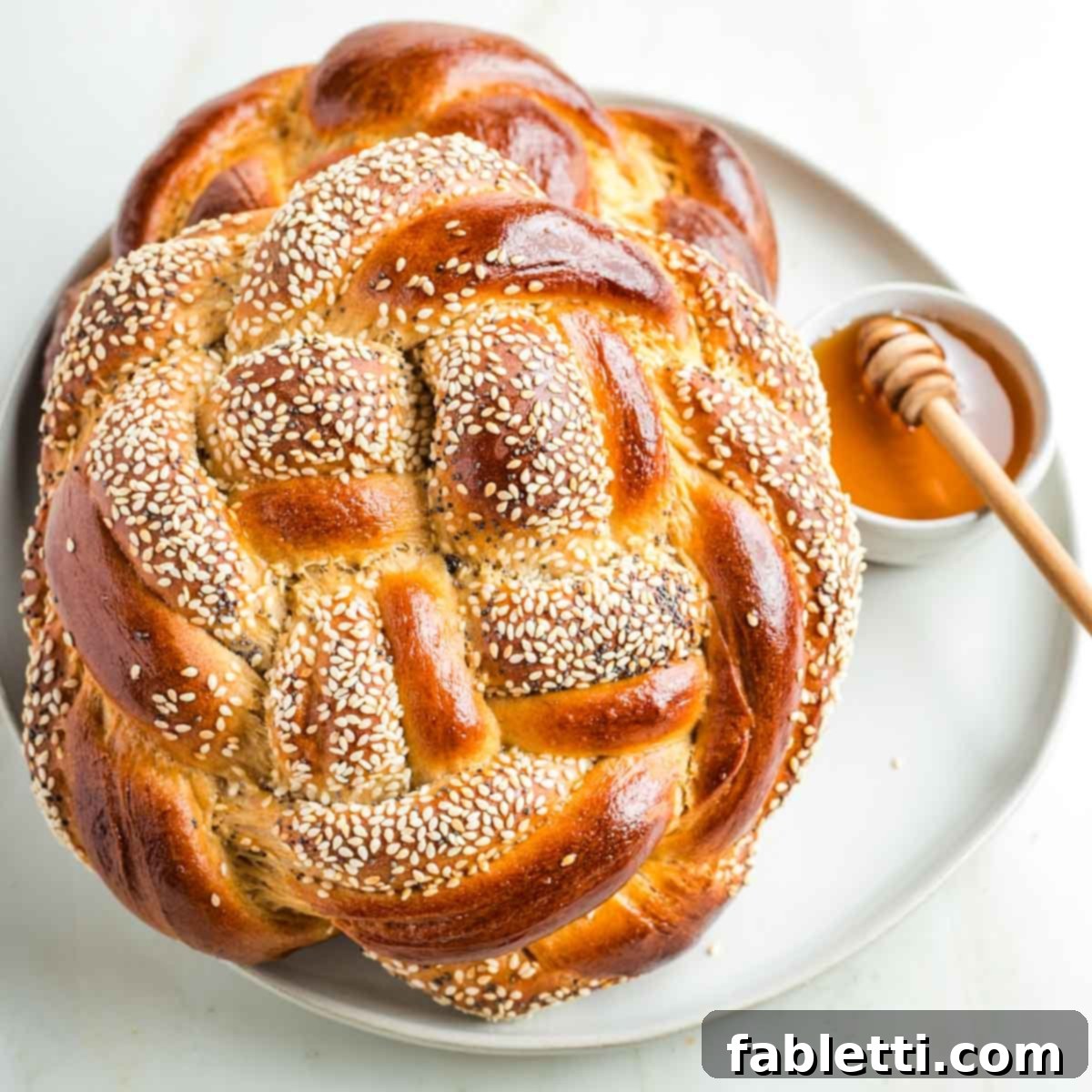 Nourishing Rosh Hashanah 2025 Recipes and Menu Inspiration 3 Round, braided challah bread with honey for dipping.