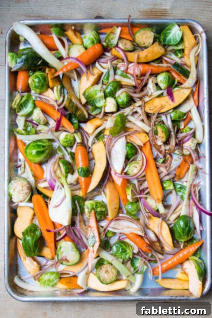 A tray of colorful root vegetables ready to roast.
