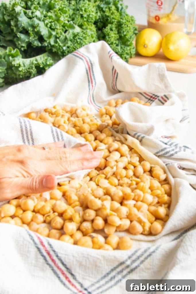A kitchen towel being used to rub the skins off chickpeas for roasting