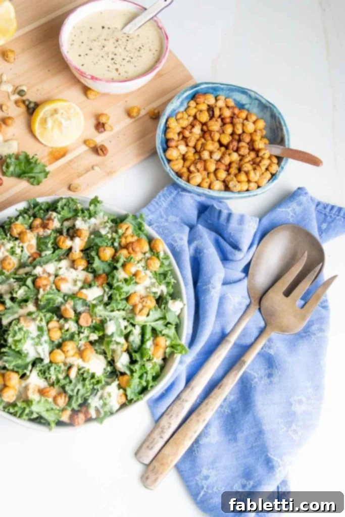 A vibrant and colorful kale salad, topped with creamy vegan dressing and crunchy chickpea croutons