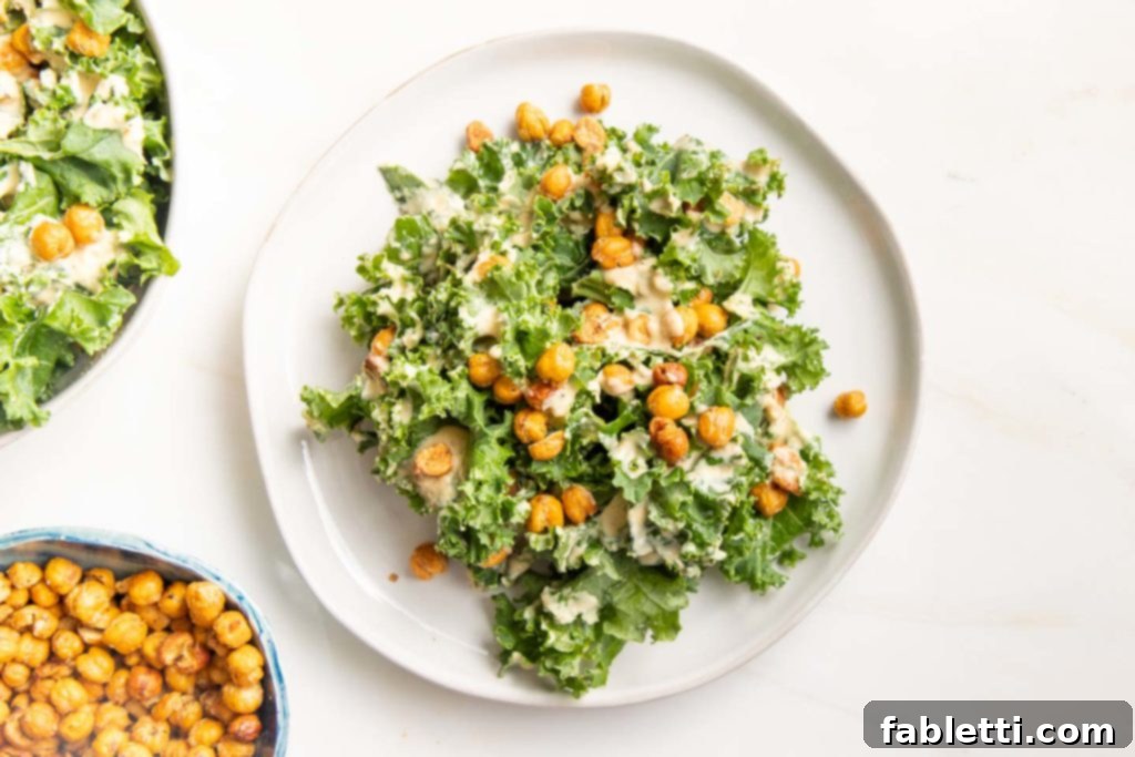 A bowl of Vegan Kale Caesar Salad featuring kale, creamy dressing, and chickpea croutons