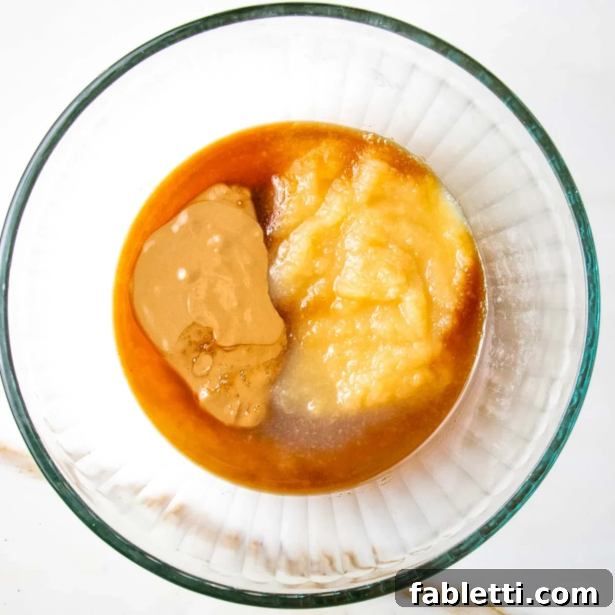 Guilt-Free Chocolate Chunk Bliss 3 Almond butter, applesauce and maple syrup in a bowl.