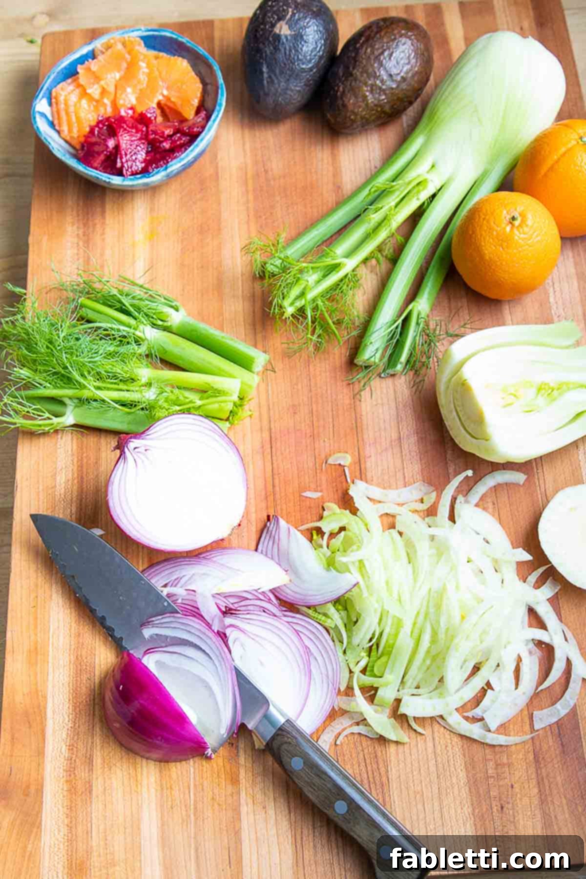 Radiant Orange Fennel 8 Showing how to slice red onion. Also shown, sliced fennel and orange slices.