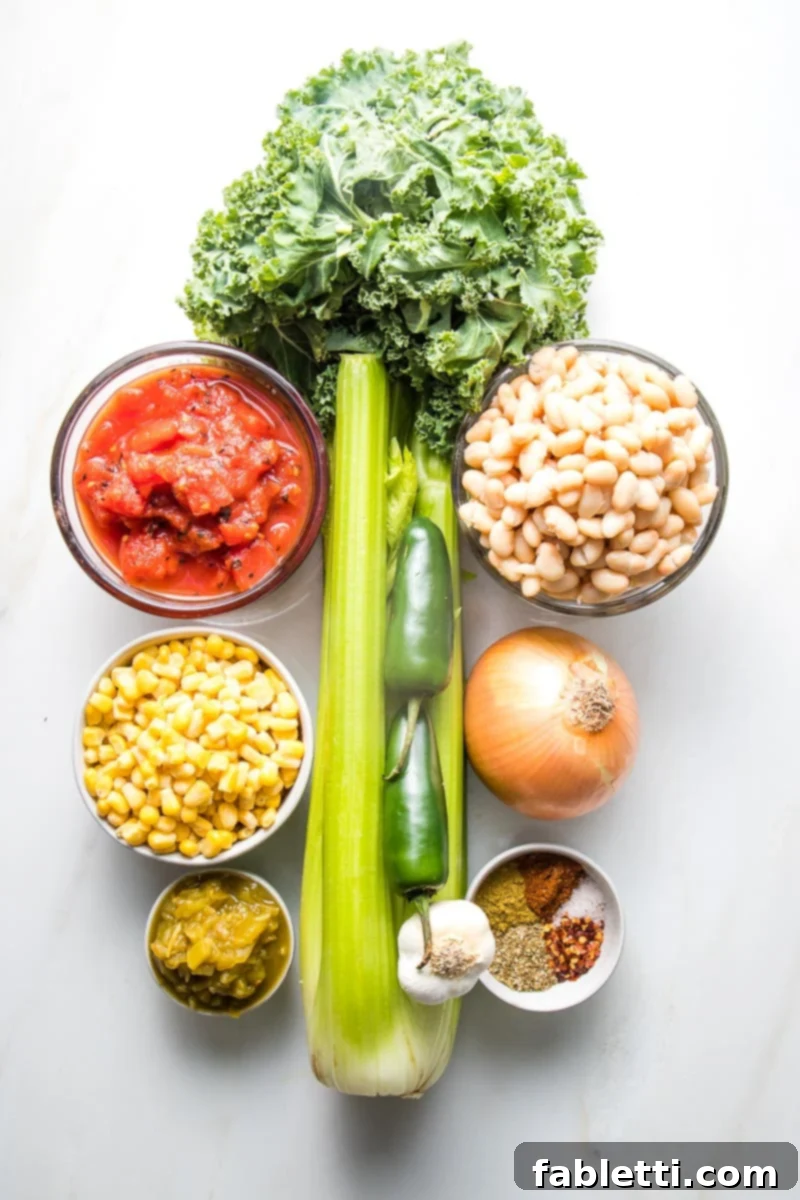 Hearty Vegan White Bean Chili 3 A vibrant display of fresh ingredients for white bean chili: crisp celery, leafy kale, plump white beans, crushed tomatoes, sweet corn, aromatic onion, a medley of spices, diced green chilis, fiery jalapenos, and fragrant garlic.