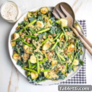 Golden Crisp Quinoa Salad with Silky Plant-Based Dressing 12 White plate with greens, veggies, crispy quinoa and a creamy dressing.