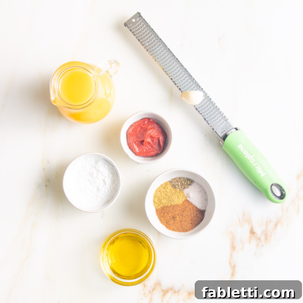 Ingredients: pitcher of veggie stock, microplane with garlic, arrowroot powder, tomato paste, olive oil, spices.