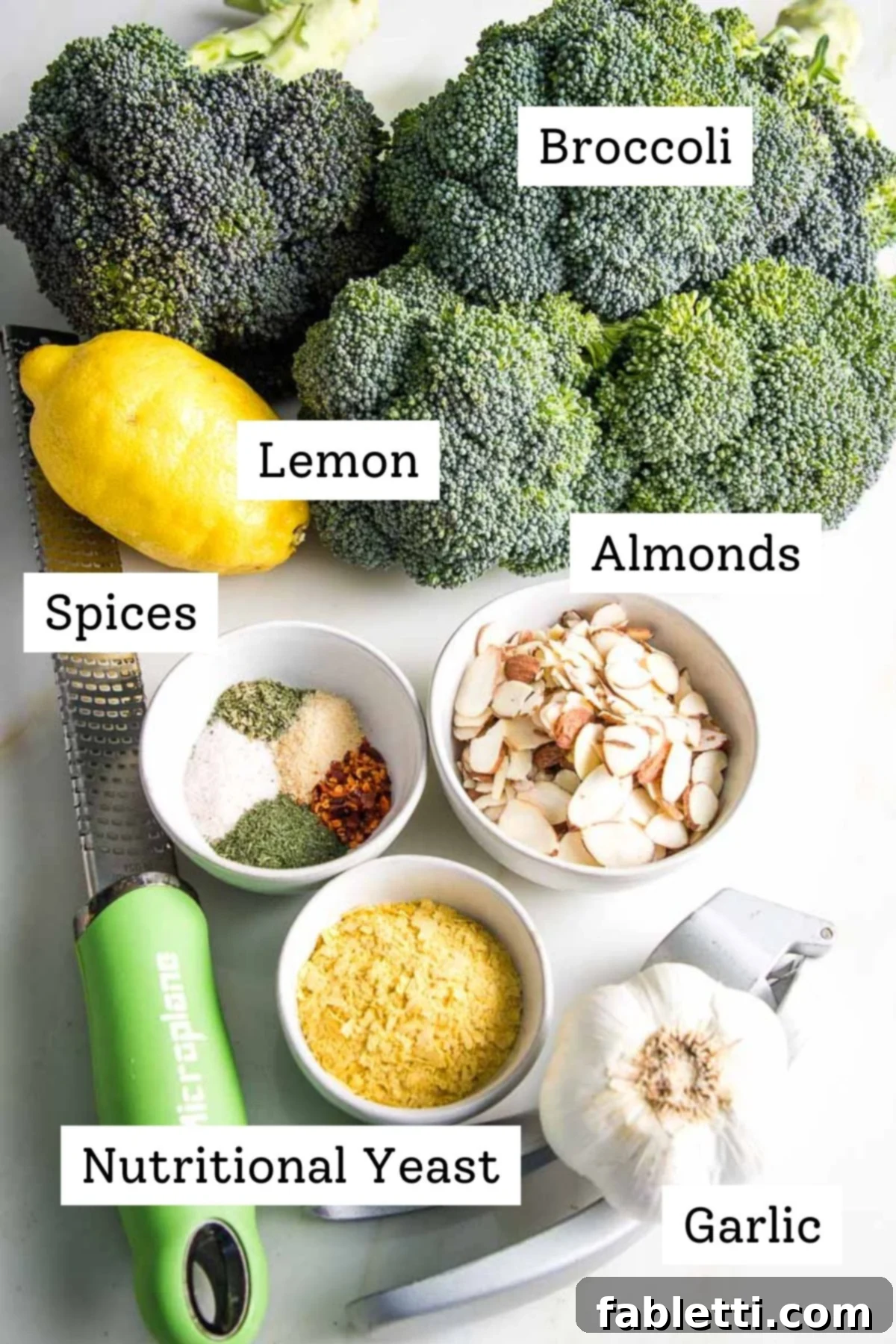 Labeled ingredients: fresh broccoli, vibrant lemon, crunchy almonds, a blend of aromatic spices, pungent garlic, and nutritional yeast for a cheesy flavor.