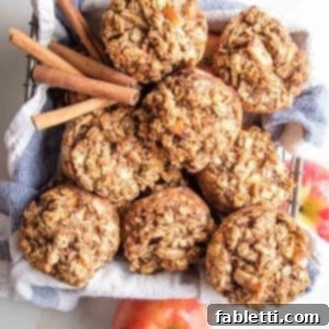 Oatmeal apple muffins in a basket with cinnamon stick and apples around.