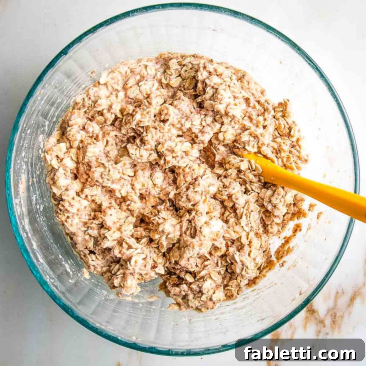The wet and dry ingredients being mixed together in one bowl until just combined.