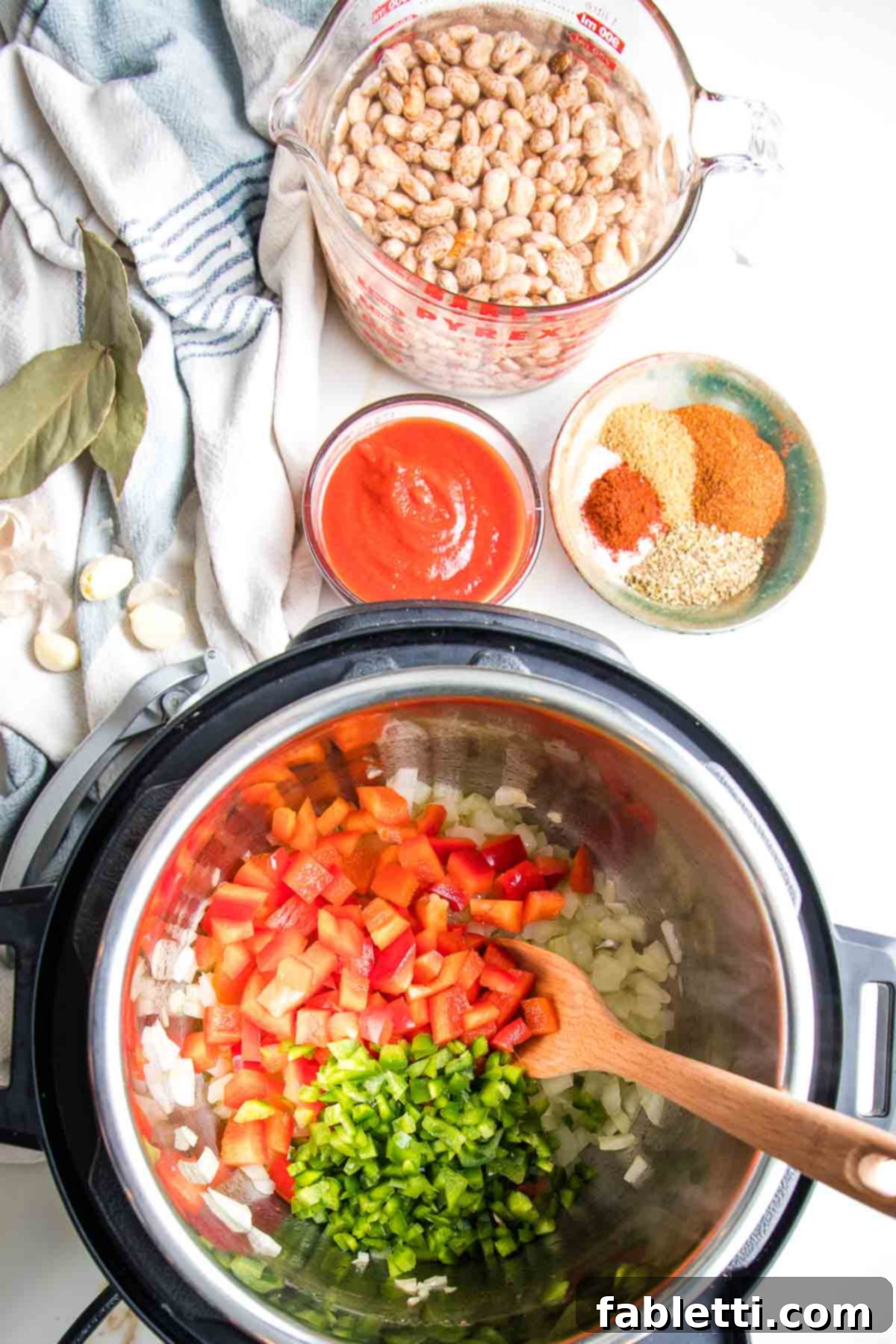 Easy Instant Pot Mexican Pinto Beans 6 Soaked dried pinto beans, tomato sauce, spices and veggies sauteeing in the instant pot.