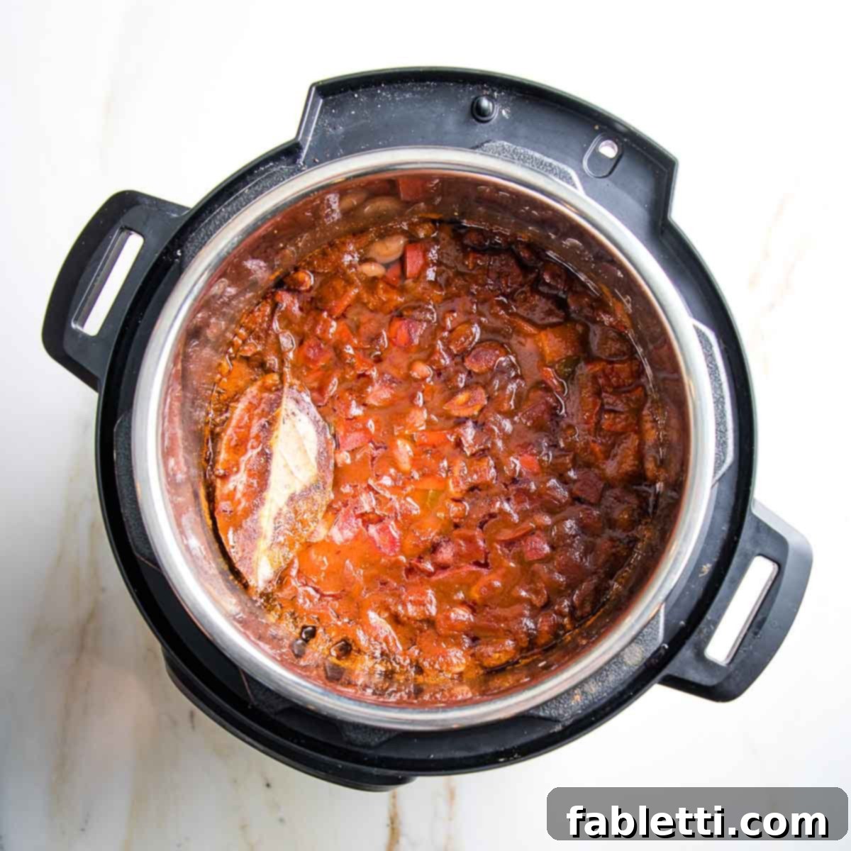 Easy Instant Pot Mexican Pinto Beans 10 Instant pot with cooked beans in tomato sauce with veggies.