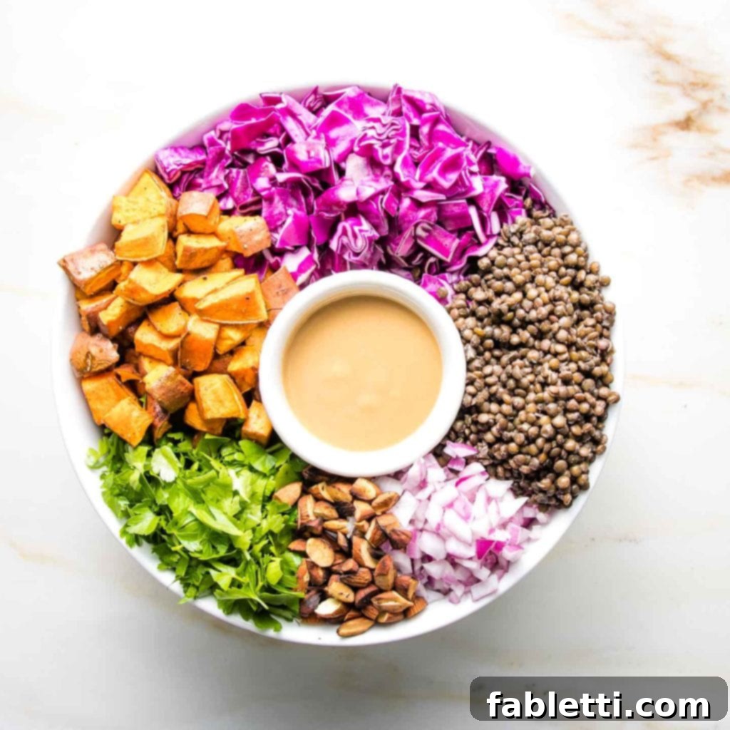 Vibrant Vegan Lentil Medley 13 A vegan lentil salad with colorful ingredients artfully arranged around a small dish of creamy miso mustard dressing.