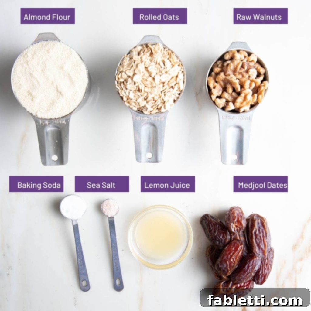 Homemade Blueberry Tart Perfection 5 A clear photo showing the ingredients for the blueberry tart crust: almond flour, oatmeal, walnuts, baking soda, sea salt, lemon juice, and dates, each labeled.