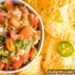 Vibrant Chunky Tomato Salsa 10 Fresh Tomatoes, Cilantro, Jalapenos and scallions chopped up for a homemade salsa, served with a side of corn chips.