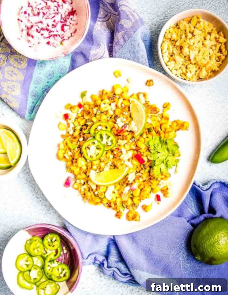Zesty Vegan Elote 2 Colorful corn salad with small bowls of extra ingredients.