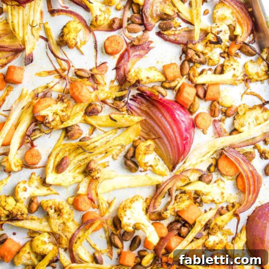 Flavorful Roasted Lentil and Vegetable Medley 8 Sheet pan with roasted fall vegetables, including carrots, fennel, and cauliflower, along with pistachios, ready to be baked in the oven for a healthy meal.