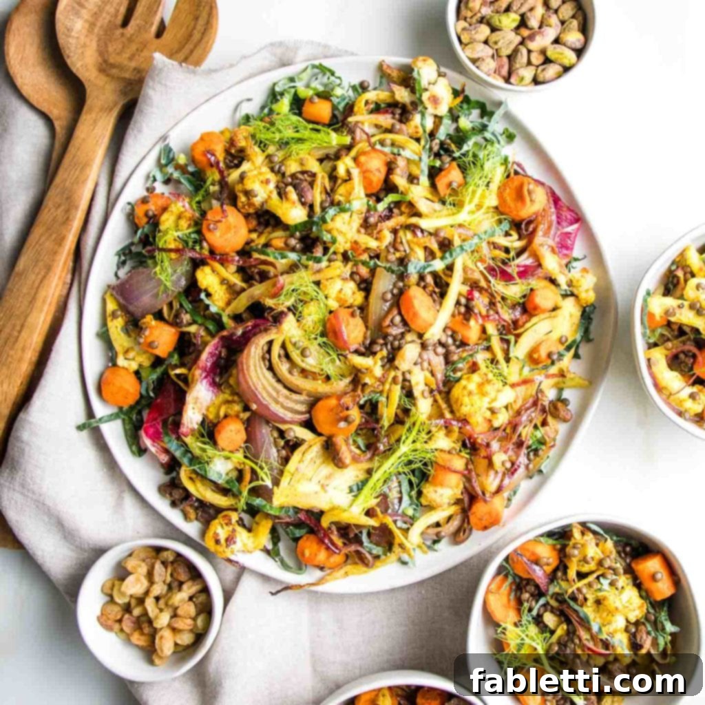 Flavorful Roasted Lentil and Vegetable Medley 9 A large white bowl filled with vibrant lentil salad, featuring roasted vegetables, pistachios, and golden raisins. The salad is garnished with fresh herbs and displayed against a rustic background, highlighting its fresh and wholesome appeal.