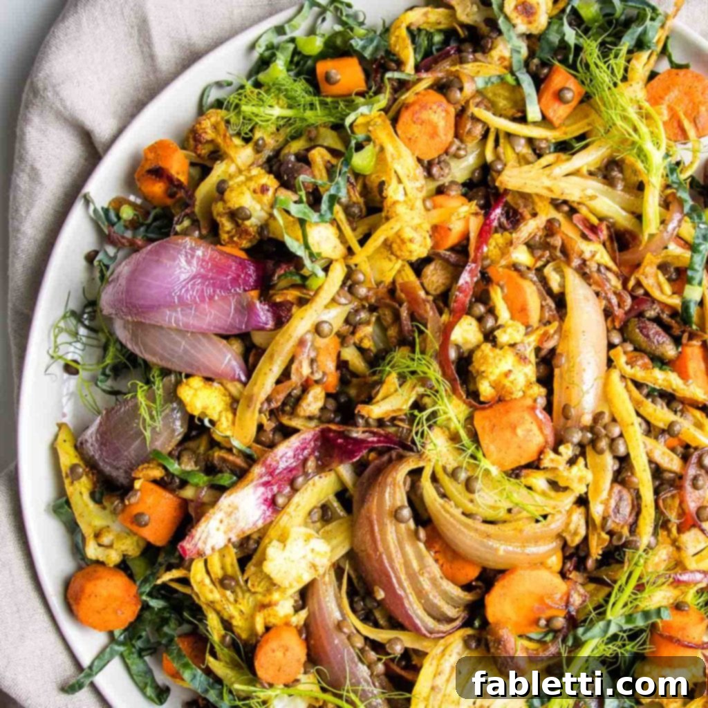Flavorful Roasted Lentil and Vegetable Medley 10 A vibrant and colorful lentil salad with roasted vegetables, pistachios, and golden raisins, served in a white bowl on a light background. The salad is garnished with fresh green herbs.