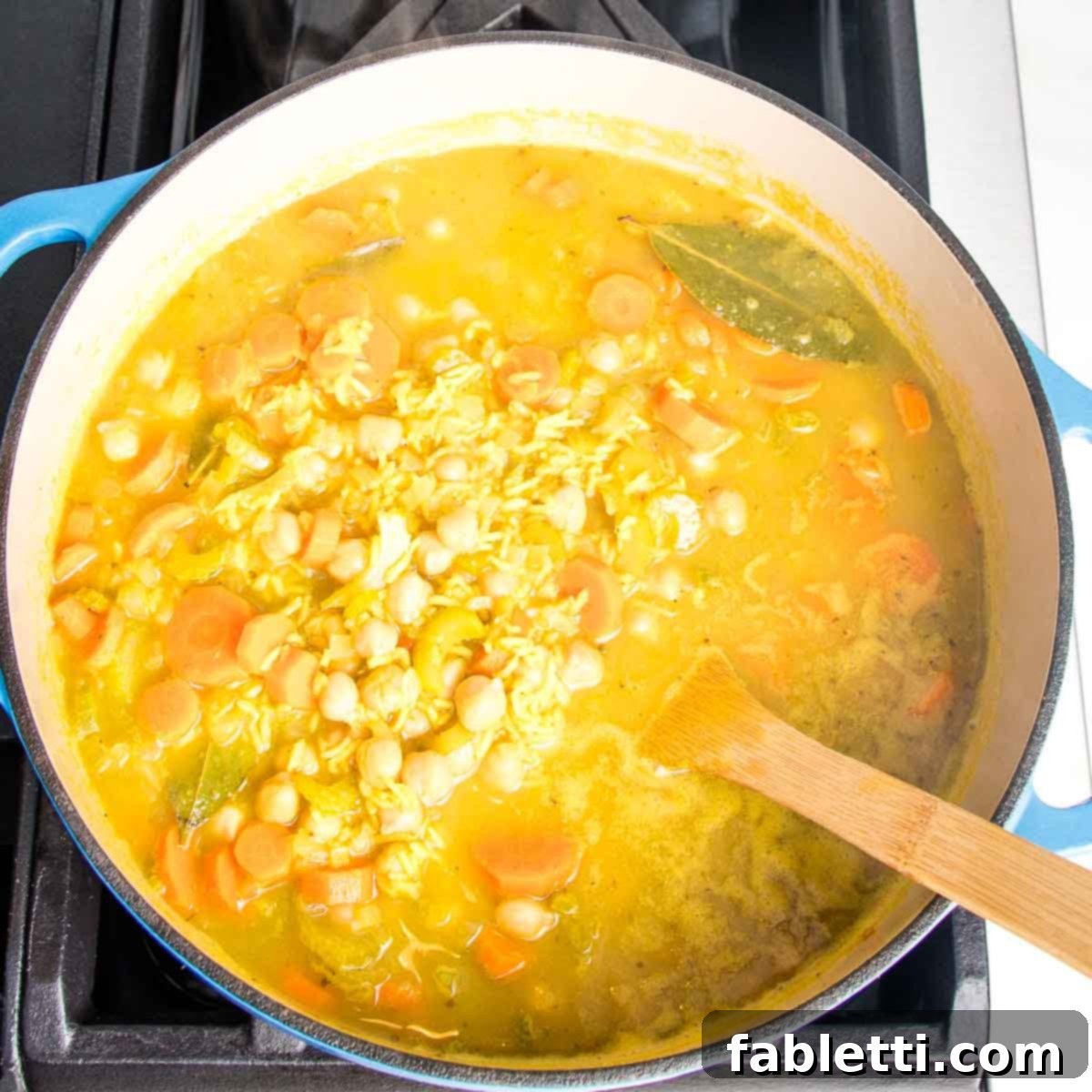 Zesty Vegan Lemon Chickpea Rice Soup 11 Dutch oven with yellow chickpea soup after simmering.