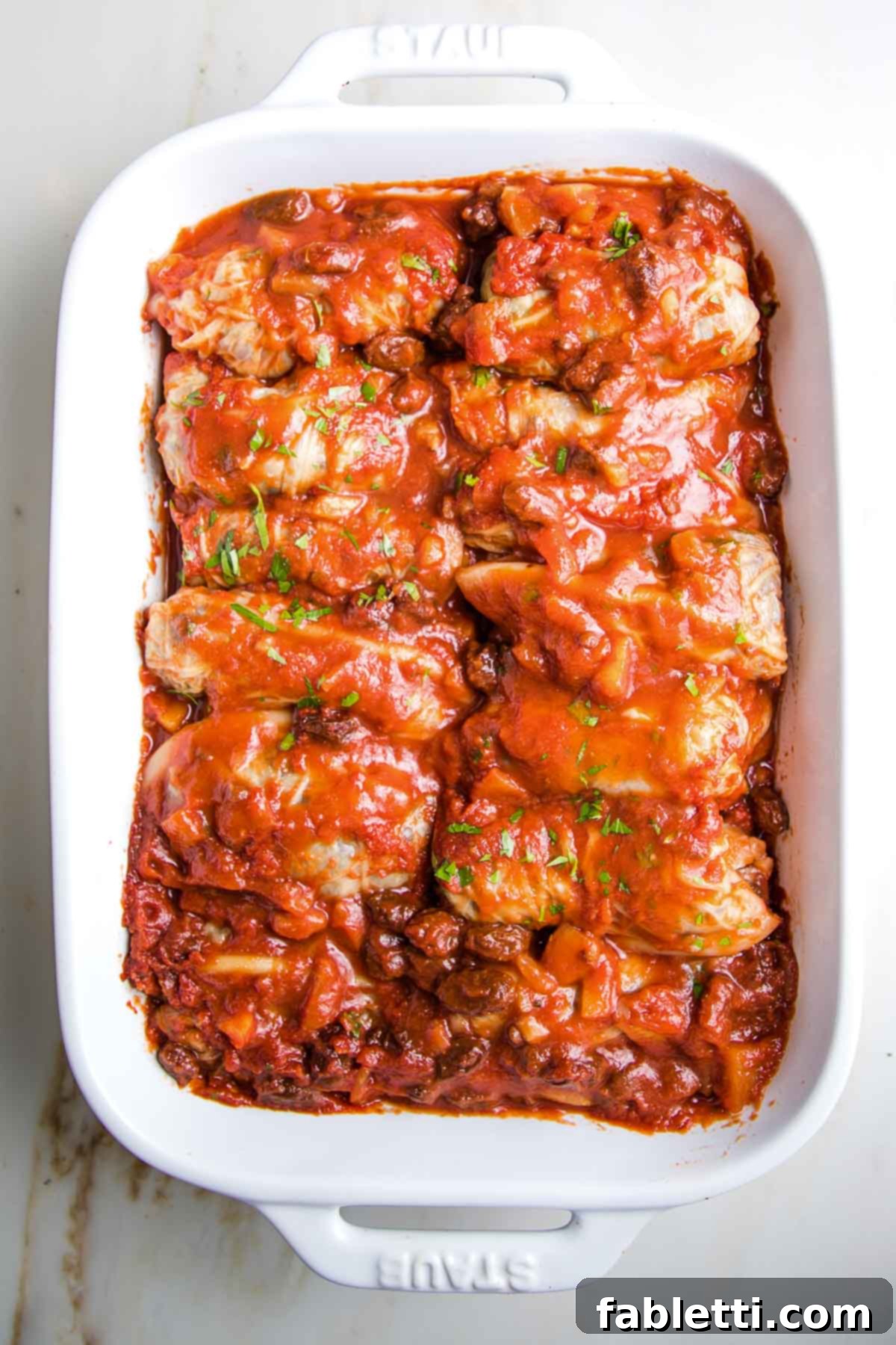 Stuffed cabbage rolls, covered in sweet and sour sauce and baked until tender.