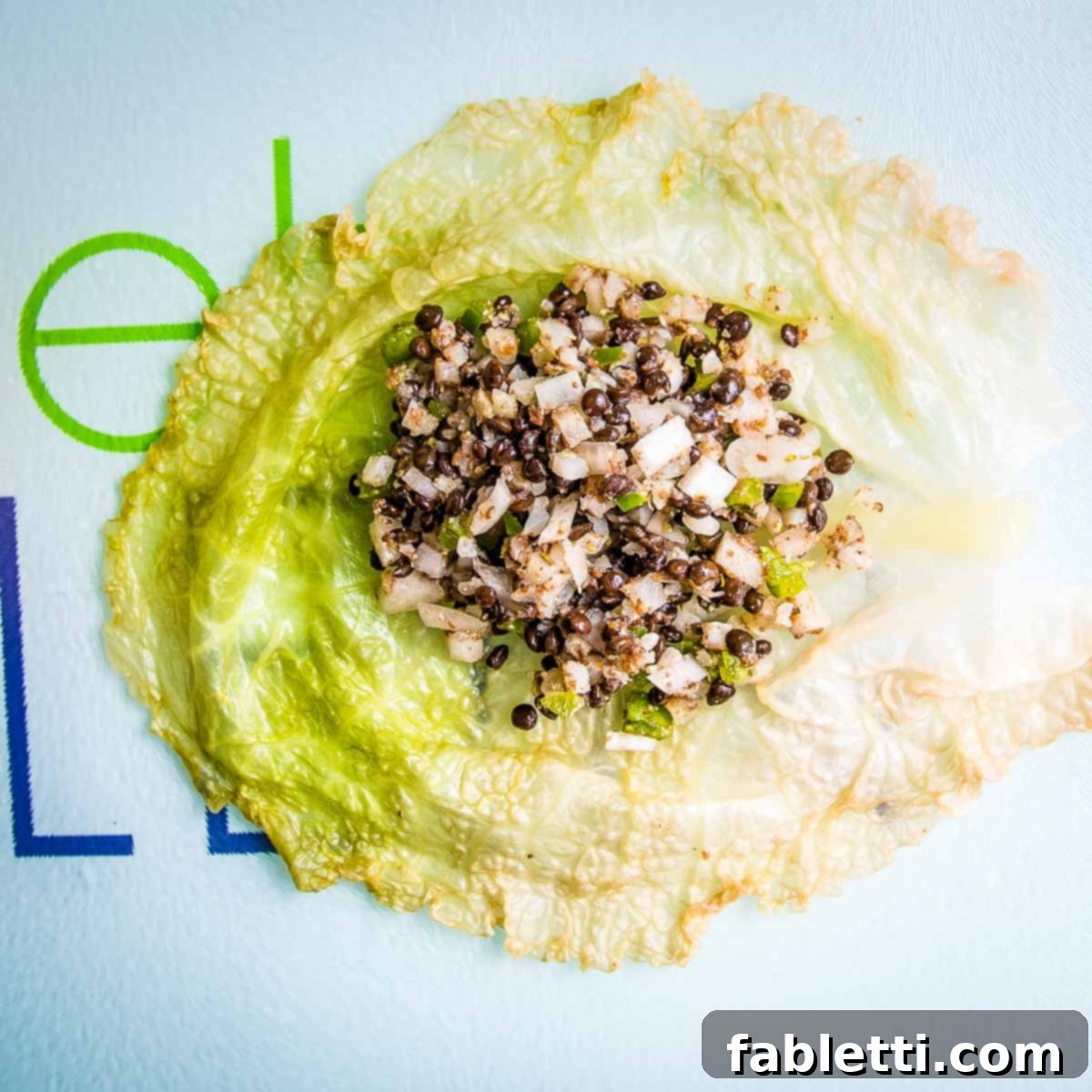 Vegan filling on top of a wilted piece of cabbage.
