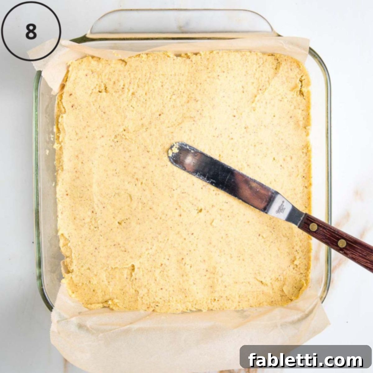 Double Corn Gluten-Free Vegan Cornbread 11 An offset spatula is used to gently smooth the thick cornbread batter evenly across the bottom of the square baking pan.