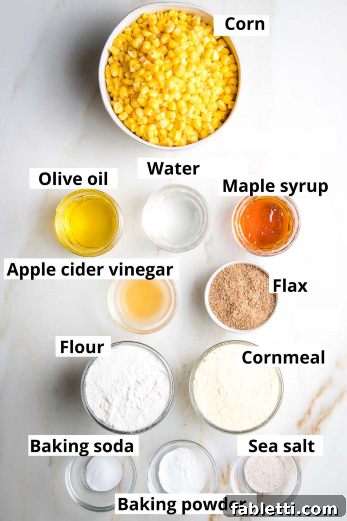 Double Corn Gluten-Free Vegan Cornbread 3 Close-up of all the dry and wet ingredients for the gluten-free vegan cornbread laid out on a wooden surface.