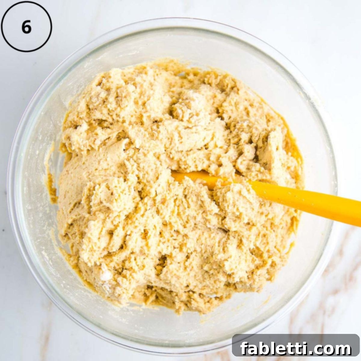 Double Corn Gluten-Free Vegan Cornbread 9 The thick cornbread batter, a mix of wet and dry ingredients, sits in a large mixing bowl, ready to be transferred to a baking pan.