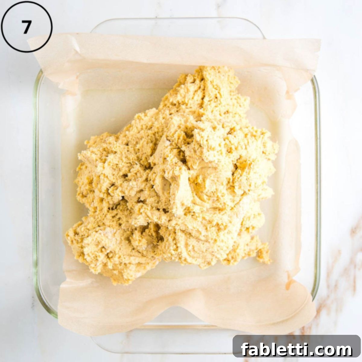 Double Corn Gluten-Free Vegan Cornbread 10 Thick cornbread batter is carefully dumped into an 8x8 inch square baking pan, which is lined with unbleached parchment paper.