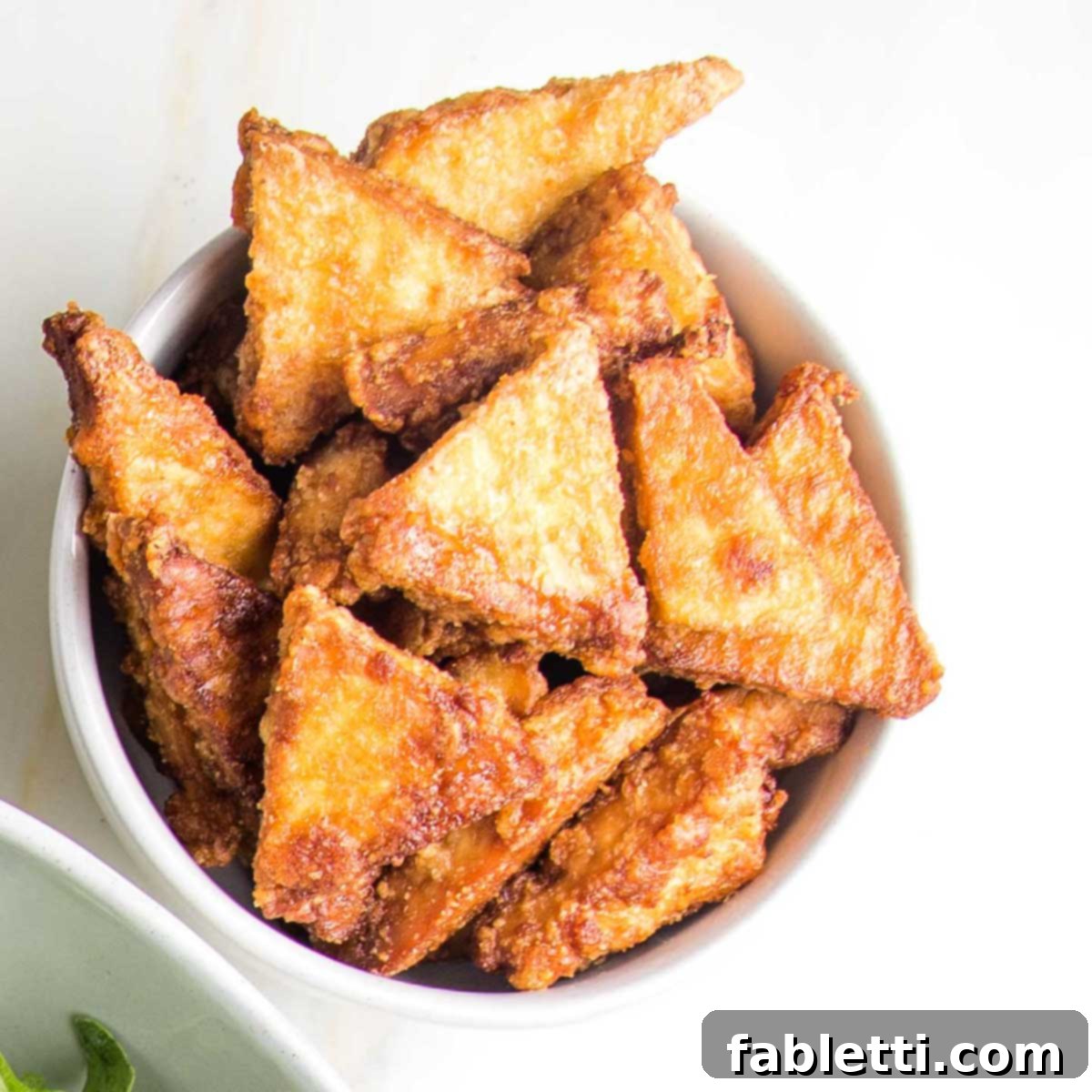 Ultimate Crispy Baked Tofu 17 Crispy tofu pieces on a baking sheet, ready to serve.