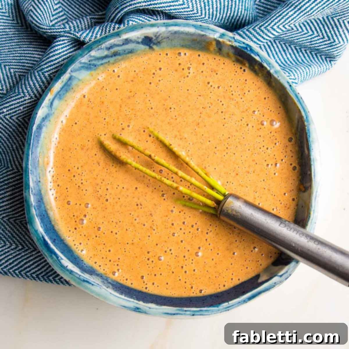 Ultimate Crispy Baked Tofu 19 Whisking the almond butter sauce ingredients together.