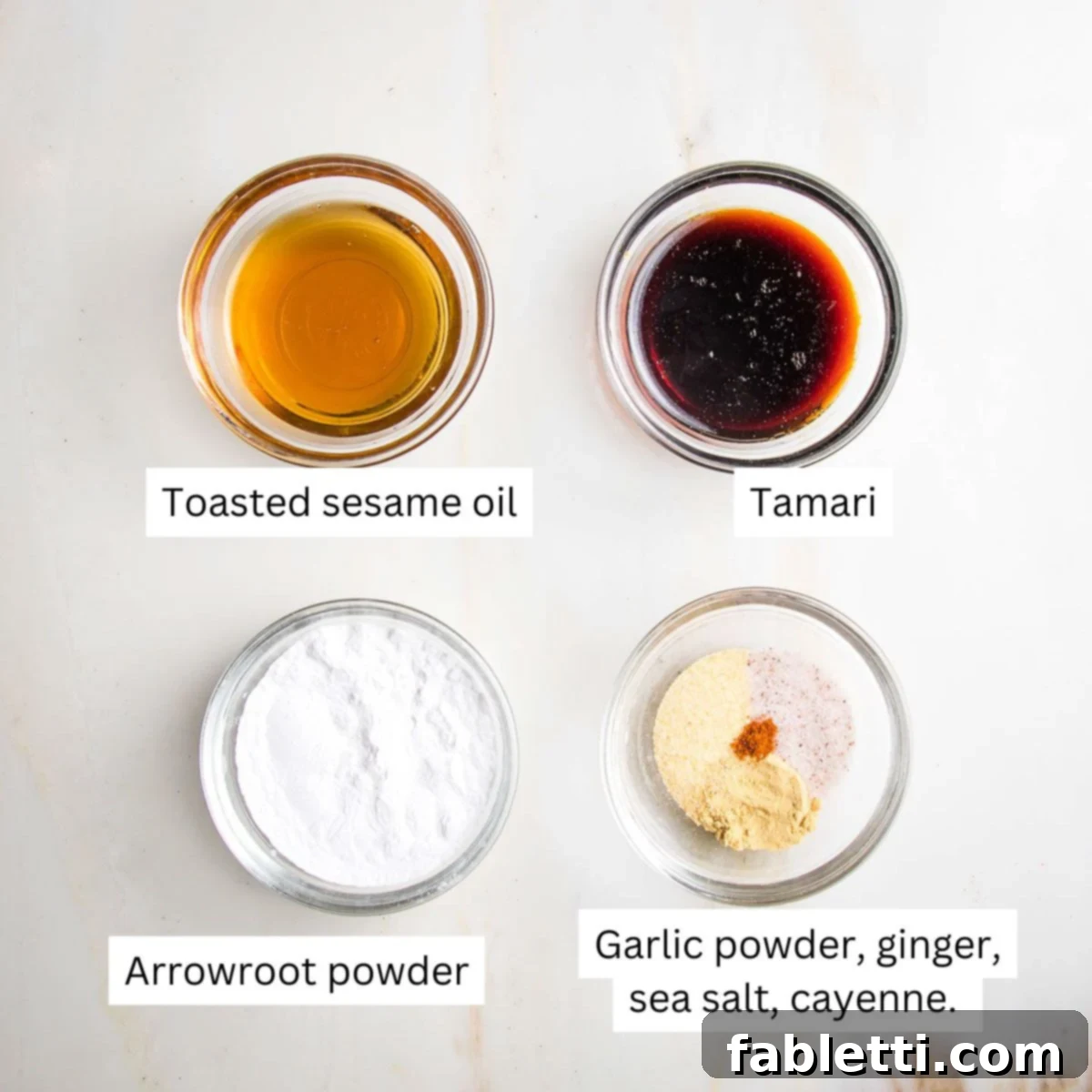 Ultimate Crispy Baked Tofu 7 Labeled small bowls with sesame oil, tamari, arrowroot and spices.