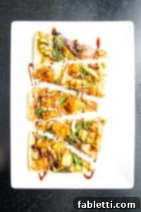 Effortless Plant-Based Flatbread 25 Small triangle appetizer flatbread pizza slices loaded with hummus, spinach, roasted squash, onions and garlic with a date syrup drizzle