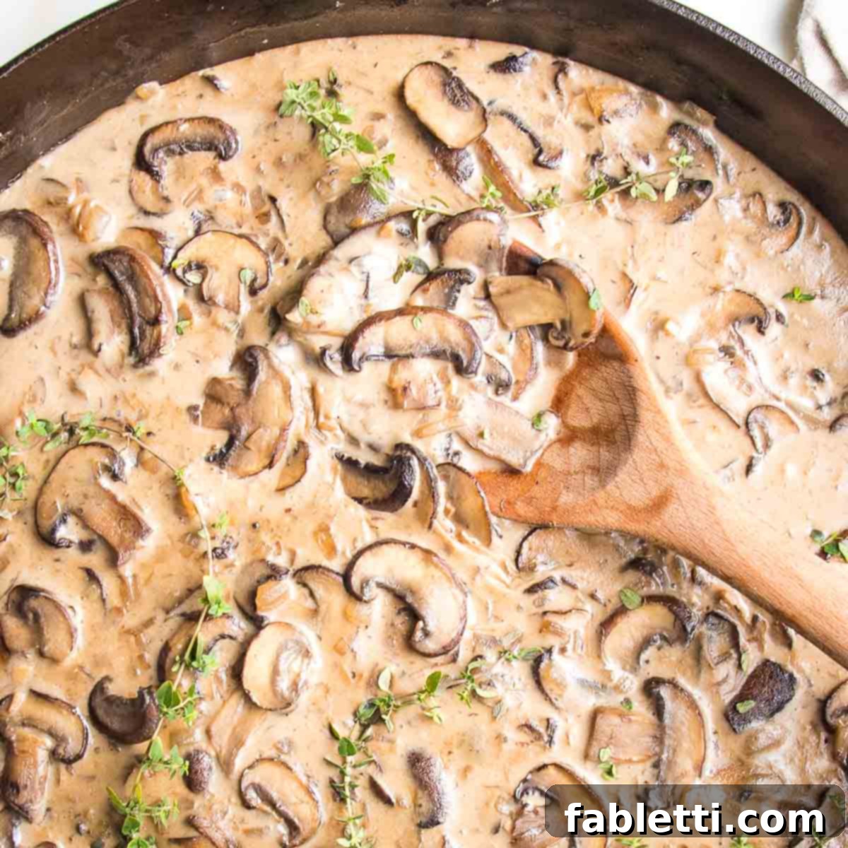 Hearty Vegan Mushroom Stroganoff 14 Close-up of a richly textured, creamy vegan mushroom stroganoff sauce with visible mushroom slices, showcasing its inviting consistency.