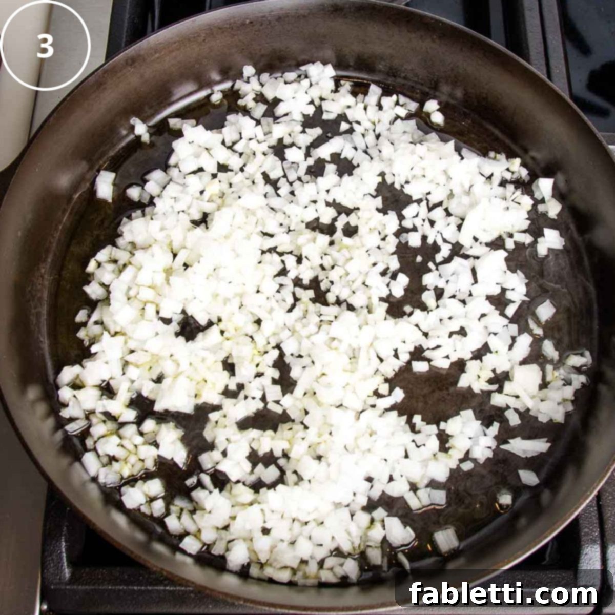 Hearty Vegan Mushroom Stroganoff 7 Onions lightly sautéing in a cast iron skillet with a small amount of vegetable broth, beginning to soften.
